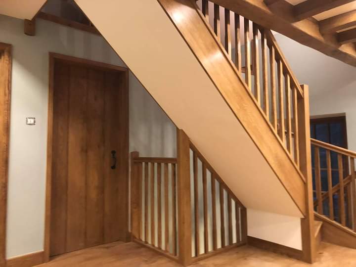 Oak staircase beside an oak plank door